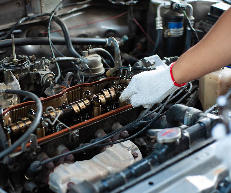 The mechanic is tuning the car's engine.