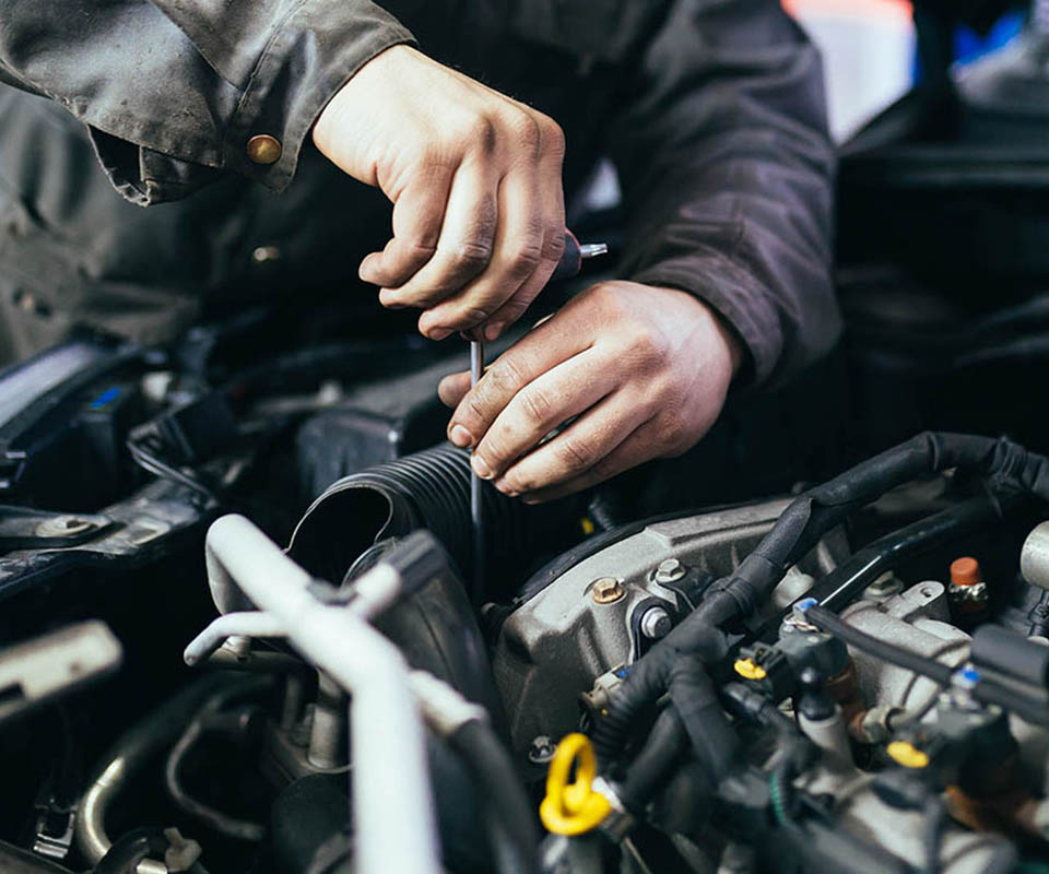 Auto mechanic repairing car. Selective focus.